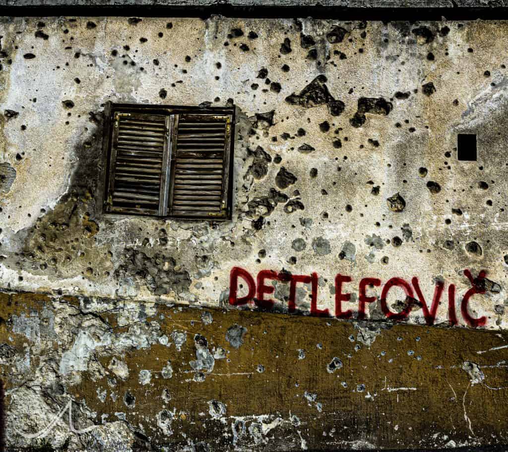 A wall riddled with bullet holes from the 1993 Siege of Mostar in Mostar, Bosnia and Herzegovina.